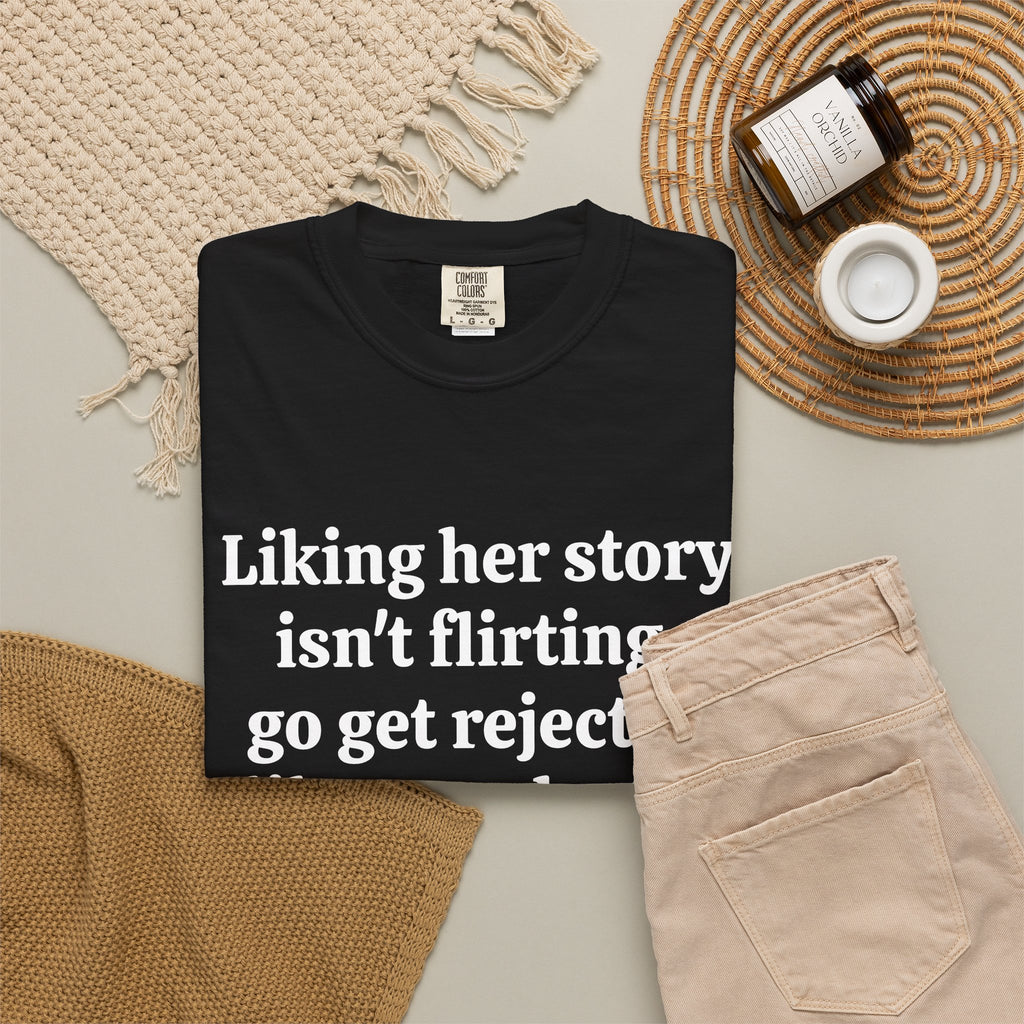 Black Rejected Like A Real Man tee folded in a flat lay with jeans and candle