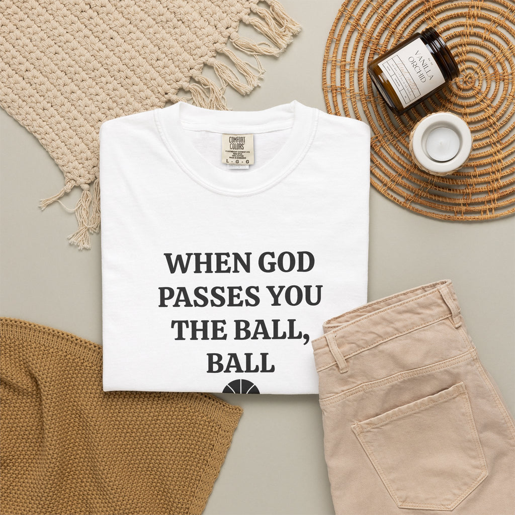 White When God Passes You The Ball, Ball tee folded in a flat lay with jeans and candle