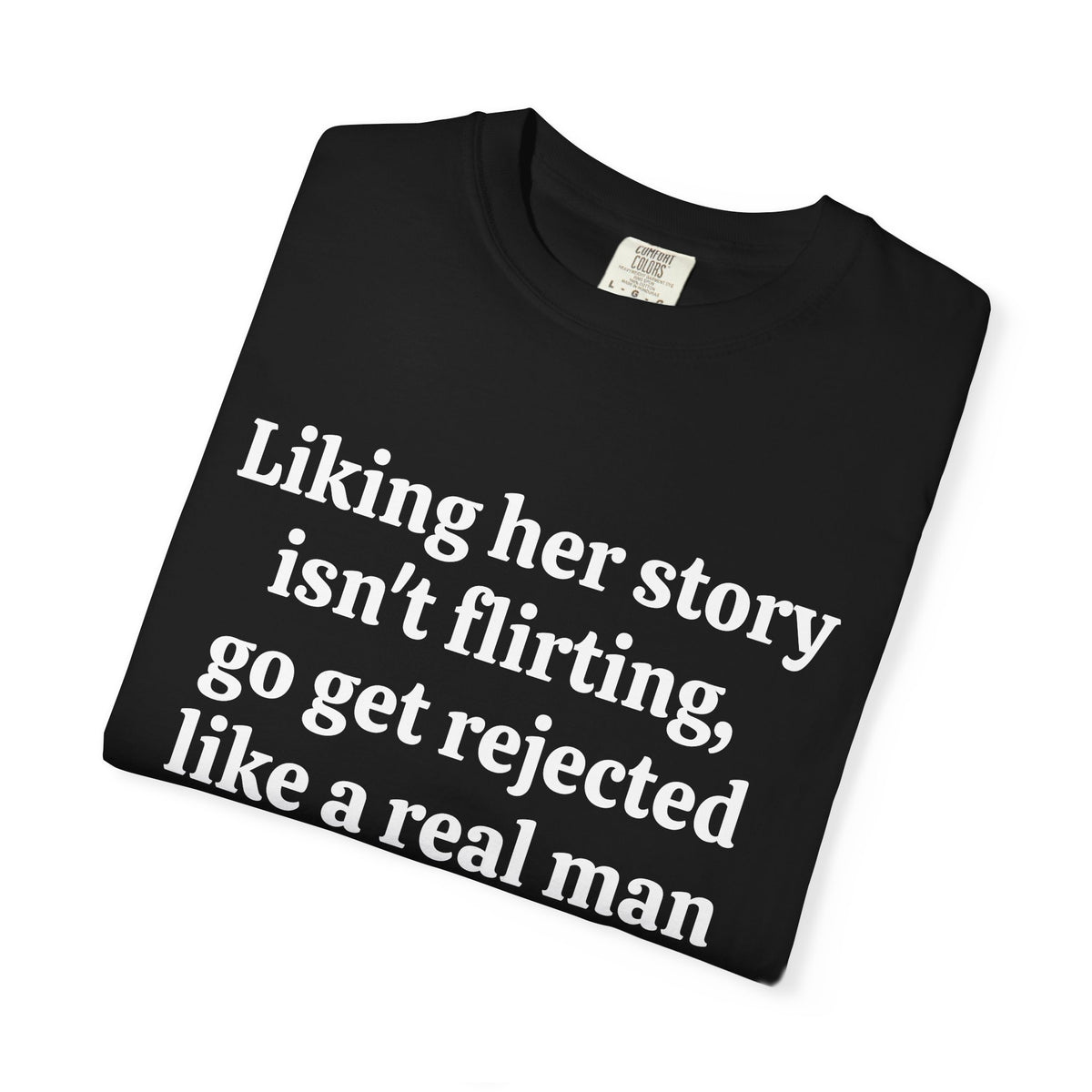 Black Rejected Like A Real Man tee folded, close-up of white print