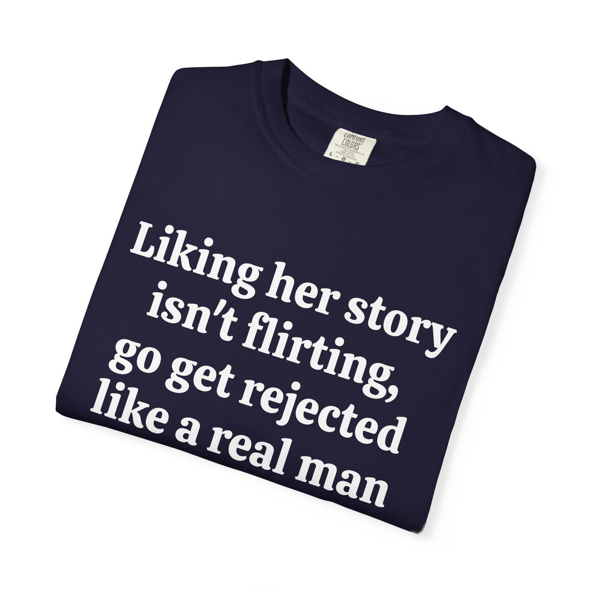 True Navy Rejected Like A Real Man tee folded, close-up of white print