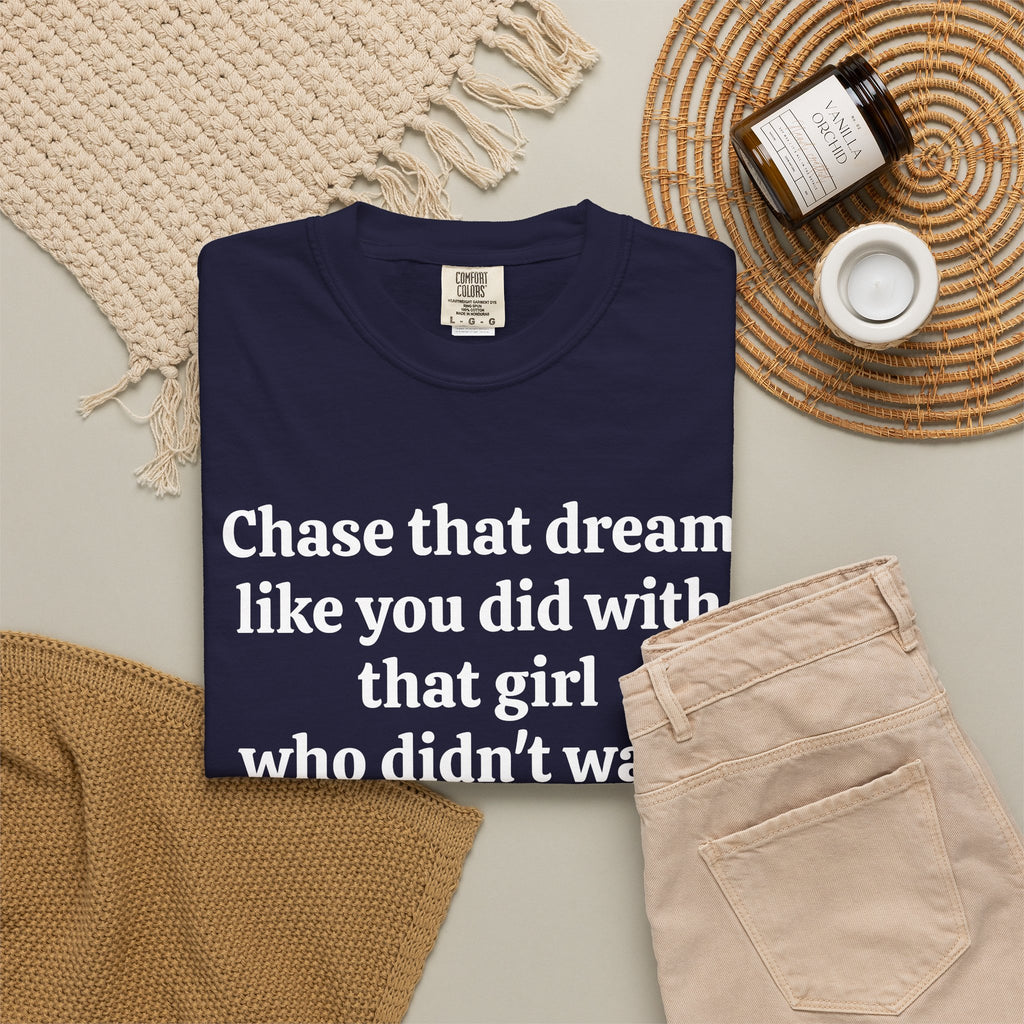 True Navy Chase That Dream tee folded in a flat lay with jeans and candle